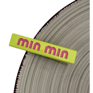 Neon green candy colored hair clip with pink engraved letters for a trendy girl style