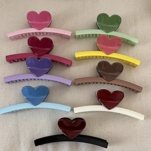 Set of 9 colorful heart-shaped claw clips in various matte finishes and vibrant tones
