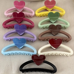 Colorful heart-shaped hair claw clips in nine vibrant shades for voluminous hair styling