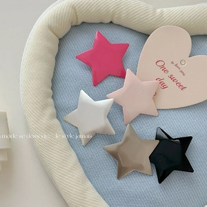 Set of five colorful matte star-shaped hair clips in pink, white, and black for girls