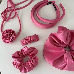Pink satin hair accessories set including headbands and scrunchies on white background