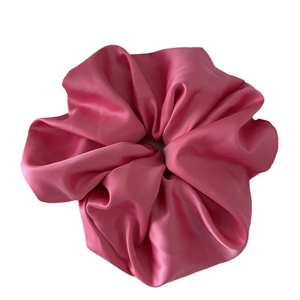 Pink satin scrunchie with silky texture and voluminous pleats for women hair styling