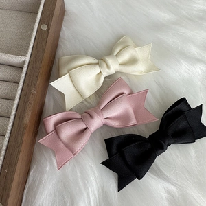 Detailed macro view of layered ribbon texture and structure on the triple bow hair clips
