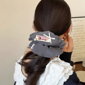 Chic dark gray oversized scrunchie with puppy button and handmade label for low ponytail