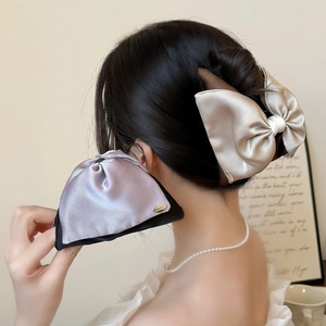 Elegant oversized champagne satin double-layered bow hair clip with black trim and gold logo