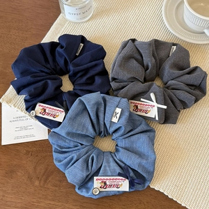 Three-piece set of large fabric scrunchies with dog labels and buttons in assorted colors