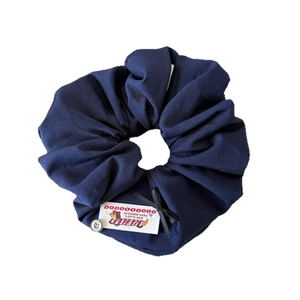 Dark blue fabric scrunchie with cute dog label, black bow and white button accessory