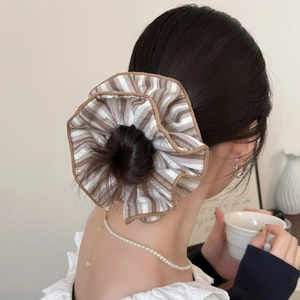 Elegant oversized brown striped fabric scrunchie with detailed hem for messy bun styles
