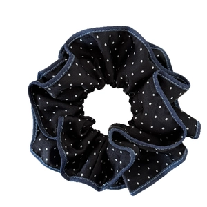 Elegant black and white polka dot scrunchie with blue denim-style ruffle edge for ponytails