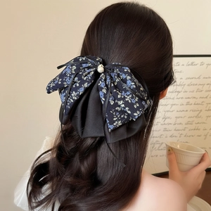 Elegant blue floral bow hair claw clip with chiffon pleats and pearl on long wavy hair