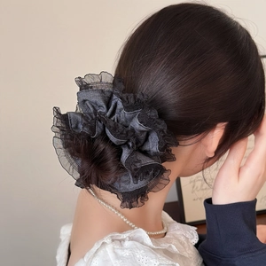 Chouchou élégant en satin gris foncé avec dentelle noire sur une coiffure en chignon