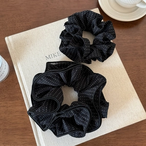 French style black polka dot scrunchie set on a book for hair accessories styling