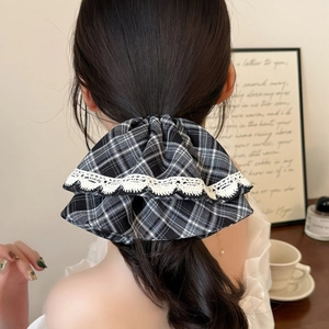 Eleganter schwarz-weißer Plaid-Haargummi mit Spitzenbesatz im Frauenhaar