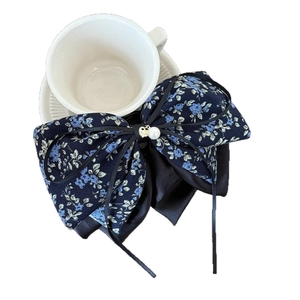 Elegant blue floral bow hair claw clip with pearl heart pendant and long black ribbons