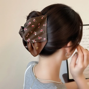 Elegant floral fabric shark hair claw clip with brown bow and golden tag for women