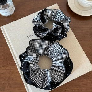 Classic black and white checkered and polka dot fabric scrunchies in a two-piece set