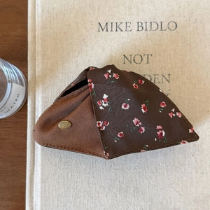 Detail of floral fabric hair claw clip with golden triangular POKO FOSCA metal logo