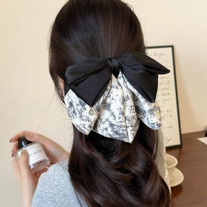 Elegant multi-layer bow hair clip with ink print pattern and black satin contrast fabric