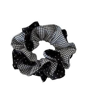 Dual-layer black and white gingham polka dot fabric scrunchie with soft ruffled layers
