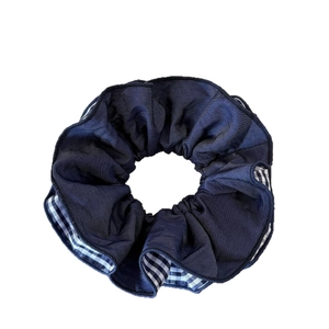 Navy blue scrunchie with white checkered inner trim and pleated fabric texture hair tie
