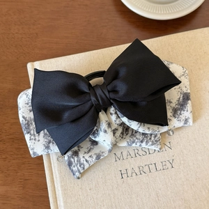 Detail of layered bow hair clip with ink wash print fabric and crystal bead pendant decor