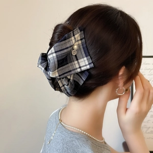 Plaid fabric hair claw clip with buttons shown on an elegant updo hairstyle
