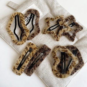Leopard print plush hair clip set in star and heart shapes on beige fabric