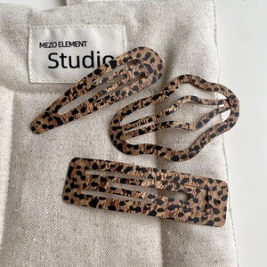 Three-piece leopard print metal hair clip set with teardrop and rectangular shapes