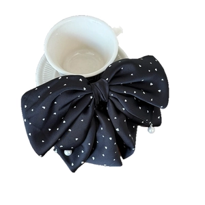 Elegant black satin bow hair clip with white heart polka dots and a hanging pearl charm