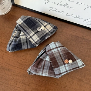 British style plaid fabric hair clips with pearl button details on a vintage desk