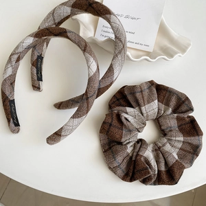 Detailed view of brown plaid knit hair accessories set including headbands and scrunchie
