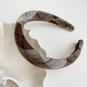 Detail of handmade brown plaid flannel headband with Hand Made label for winter fashion