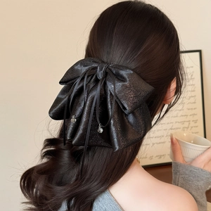 Elegant large black satin bow hair clip with sparkling finish and heart pendants