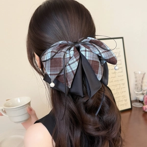 Elegant plaid bow hair claw clip with pearl pendants shown in a half-up hairstyle