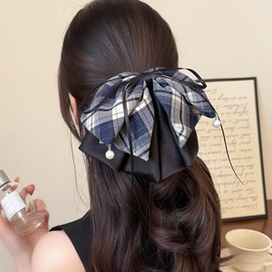 Plaid ribbon bow hair claw clip with pearl pendants in a stylish half-up hairstyle
