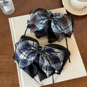 Checkered bow hair claw clips with black ribbons and pearls in a vintage setting