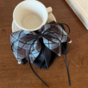 Detail of vintage plaid bow hair claw with black ribbons and small white pearls