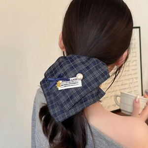 British style green plaid scrunchie with pearl and gold bear charm on long black hair