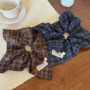 Maillard brown and navy plaid scrunchies with cute gold bear charms and ribbon bow