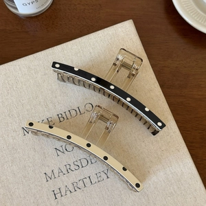 Minimalist black and white polka dot claw clips set with transparent amber resin base