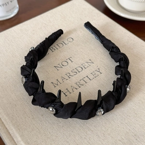 Detail of black twisted fabric headband with crystals and inner non-slip hand made label