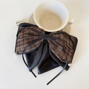 Plaid and black satin hair claw clip with pearl accents for elegant autumn styles
