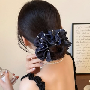 Navy blue denim scrunchie with white rabbit prints on a bun hairstyle for women