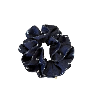 Navy blue denim scrunchie with white bear pattern and small gold pendant charm