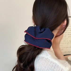 Retro navy blue heart scrunchie with red polka dots and trimmed edges for ponytail