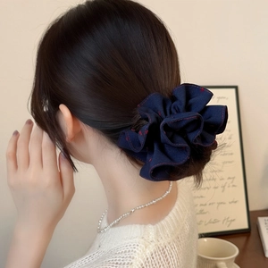 Dark blue denim scrunchie with red stitching worn on a ponytail for a Korean style look