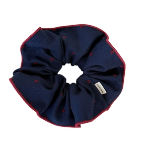 Navy blue fabric scrunchie with red heart patterns and handmade label for ponytails