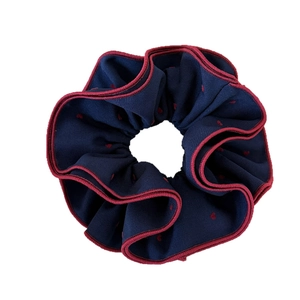 Navy blue polka dot hair scrunchie with red edges and elegant ruffled wavy design