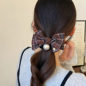 British style brown plaid bow hair tie with large pearl accent on female ponytail hair