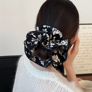Floral multilayer scrunchie in black and white with ruffled pleated fabric for bun hairstyles